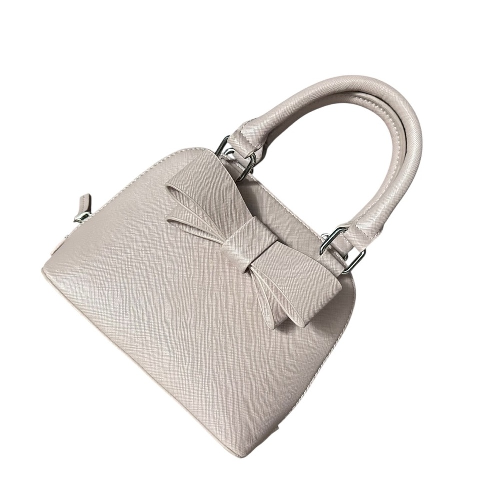 Betsey Johnson mini satchel bag in blush pink faux leather with a bow detail.
